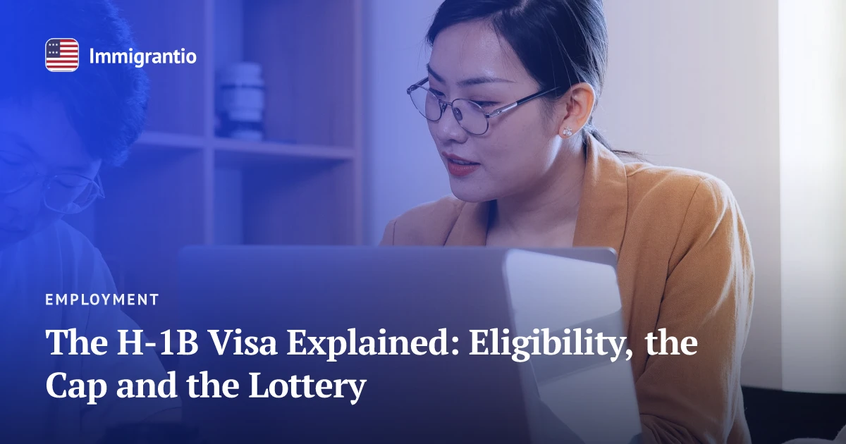 Colleagues working on a laptop — H-1B visa guide